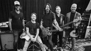 Dave Grohl holding his Epiphone DG-335 signature guitar, in the new Foo Fighters promo pic